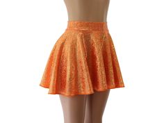 "This skirt features a sparkly gold and neon orange hologram spandex.   SKIRT LENGTHS Length of skirts vary by size below.   Please submit a custom request for lengths not shown.   FRONT/BACK Toddler 2/37\"/8\" Child X-Small        10\" /       11\" Child Small11\"/12\" Child 6X-711\"/12\" Child Medium13\"/14\" Child Large13\"/14\" Adult XS        13\"/14\" Adult Small        15\"     /   16\" Adult Medium15\" /16\" Adult Large16\"/17\" Adult X-Large17\"/18\" Adult 2X        17\"     /   18\" Ad Shiny Stretch Mini Skirt, Fitted Gold Mini Skirt With Lining, Shiny Stretch Mini Skirt Bottoms, Fitted Orange Mini Skirt, Orange Fitted Mini Skirt, Fitted Orange Skirt, Orange Lined Mini Skirt For Party, Fitted Orange Skort, Disco Fitted Mini Skirt