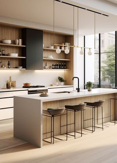 a modern kitchen with an island and bar stools