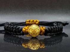 Gift yourself or your love once this Unisex Money Ball Bracelet. Crafted with 24 Karat Gold amd Mandala String. *Karat: Au999 Pure Gold *Gold Color: Yellow *Gold Weight; 1.63grams *LENGTH: Adjustable *Band Width: 10.4mm *Money Ball Size: 14.1mm *Real 24K Gold. NOT gold filled. NOT gold Plated. Pls message us if you want to customize your bracelet a certain way and we'll be happy to help you 💥PLS FOLLOW US AND CHECK OUR OTHER LISTINGS. WE HAVE NEW STOCKS LISTED DAILY/WEEKLY. 📬S H I P P I N G WE Adjustable Gold Bracelet Wristband, Adjustable Gold Wristband Bracelet, Gold Beaded Bracelets With Round Beads For Puja, Gold Beaded Bracelet With Round Beads For Puja, Gold Beaded Bracelet For Puja With Round Beads, Gold Spiritual Beaded Bracelet For Puja, Gold Spiritual Wristband With Round Beads, Adjustable Gold Wristband For Gift, Adjustable Gold Wristband As Gift