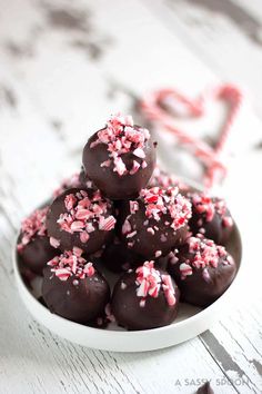 a white plate filled with chocolate covered candies and sprinkles on top