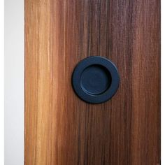 a wooden door with a black knob on it