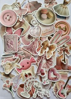 a pile of pink and white stickers sitting on top of a table