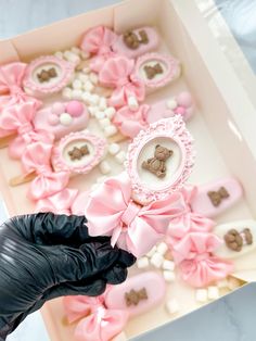 a box filled with lots of pink and brown cookies