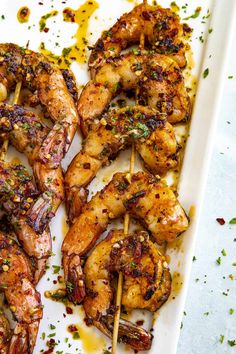 grilled shrimp skewers on a white tray