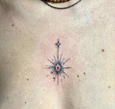 a close up of a person's chest with a compass tattoo on the chest