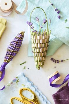 some scissors are sitting on a table next to lavenders and other crafting supplies