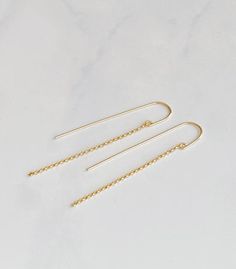 These simple modern threaders are lightweight and make great everyday earrings.  The threader is hand forged from 14kt gold filled wire into a curved U shape. 14kt gold filled rolo chain dangles from the front of the threader.  The drop length of the chain is 2 1/2” Delicate Chain Threader Earrings For Everyday, Delicate Threader Earrings With Chain For Everyday, Delicate Everyday Threader Earrings With Chain, 14k Gold Filled Threader Earrings For Everyday, Everyday 14k Gold Filled Long Drop Earrings, Everyday Long Drop Threader Earrings With Adjustable Chain, Delicate Long Drop Threader Earrings With Chain, Simple Gold Threader Earrings, Delicate 14k Gold Filled Threader Earrings