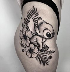 a woman's thigh with an image of a koala and flowers on it