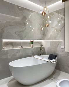 a large white bath tub sitting in the middle of a bathroom