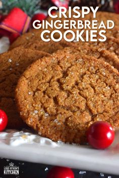 crispy gingerbread cookies on a white plate with candy canes and christmas decorations in the background