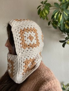 a woman wearing a crocheted hat and scarf