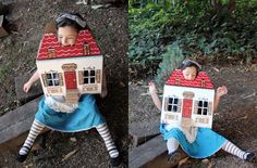 two children are sitting on the ground with their houses made out of cardboard