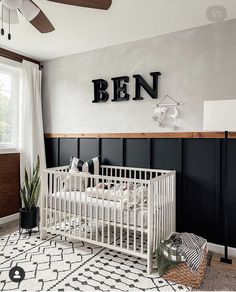 a white crib in a black and white nursery