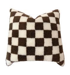 a brown and white checkered pillow sitting on top of a chair