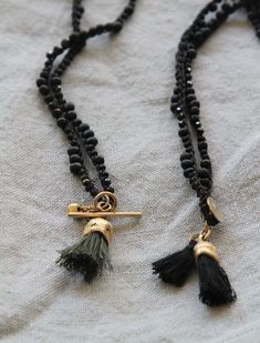 "Gold tassel eucalyptus fruit shape pendent made of brass with 22K gold plating (nickel free) and special hand made knitted black cotton thread with spinel and black miyuki chain. This Gold & black unique necklace is handmade with great attention to details, the organic golden piece is cast originally from nature and this is what makes each pendant different from one other. It is lightweight and comfortable to wear (the cotton chain it is a great solution for people with metal allergies), su Bohemian Black Hand Knotted Jewelry, Black Tassel Necklace With Adjustable Fit, Adjustable Black Tassel Necklace, Black Tassel Necklaces As Gift, Black Tassel Necklace Gift, Black Tassel Necklace As Gift, Adjustable Black Hand Knotted Necklace, Black Hand Knotted Adjustable Necklace, Organic Necklace