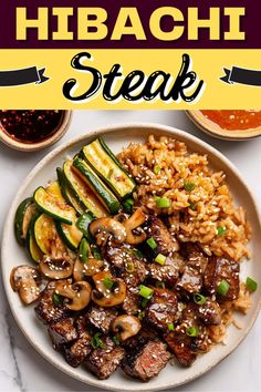 a plate filled with meat, rice and veggies on top of a table