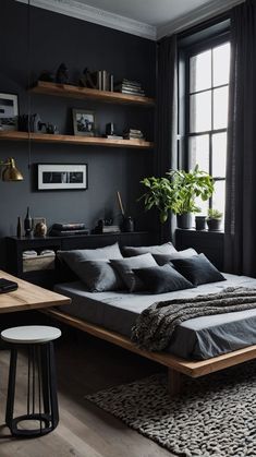 a bed sitting in a bedroom next to a desk and window with potted plants on it