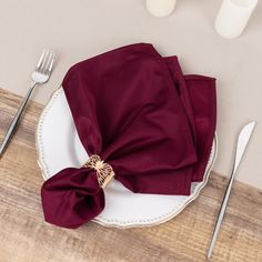 a place setting with napkins and silverware