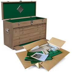 an open briefcase sitting on top of cardboard boxes next to papers and other items in it