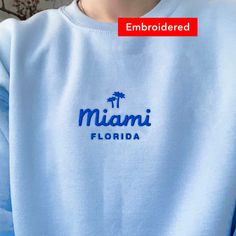 "*SIZES ARE UNISEX* -I'd suggest your usual size for a regular fit, or sizing up for a more relaxed fit. *these sweatshirts are extra comfy when oversized 🌴 \"Miami Florida\" embroidered on a comfy vintage-style crewneck. This cute crewneck is inspired by brandy melville and vintage nike sweatshirts. Perfect for any occasion or gift for him or her. A sturdy and warm sweatshirt bound to keep you warm in the colder months. A pre-shrunk, classic fit sweater that's made with air-jet spun yarn for a Relaxed Fit Crew Sweater With Embroidered Logo, Vsco Crew Neck Sweatshirt For Streetwear, Casual Crew Neck Sweater With Embroidered Logo, Summer Relaxed Fit Crew Neck Sweater, Trendy Embroidered Logo Tops For Loungewear, Summer Cotton Crew Neck Sweater, Casual Embroidered Crew T-shirt, Blue Embroidered Text Sweatshirt With Relaxed Fit, Trendy Oversized Sweatshirt With Letter Embroidery