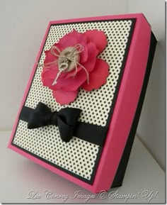 a pink and black box with a flower on it