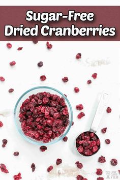 a bowl filled with cranberries next to a spoon