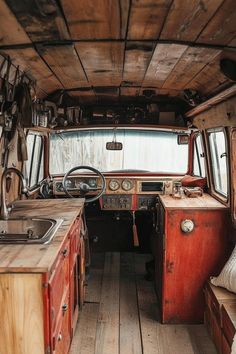 the interior of an old bus with wood flooring and wooden cabinets on both sides