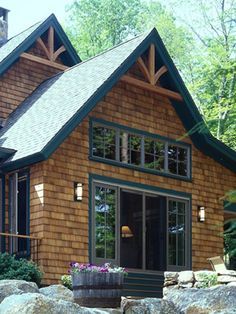 a small wooden house surrounded by rocks and trees