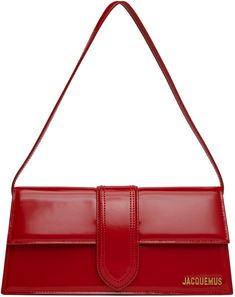 Structured patent calfskin shoulder bag in red. · Fixed shoulder strap · Logo hardware at face · Patch pocket at back face · Magnetic flap · Patch pocket at interior · Cotton twill lining · Logo-engraved gold-tone hardware · H5.25 x W11 x D2.5 Part of the Le Chouchou collection. Supplier color: Red Jacquemus Bambino, Jacquemus Red, Wardrobe Revamp, Jacquemus Bag, Face Patches, Free Bag, Cotton Twill, Patch Pocket, Bags Women