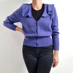 Beautiful vintage ladies cardigan in violet with frilly v-neckline collar. It has a high, ribbed hemline and sparkly, black buttons fastening. Medium thickness, warm, made from soft wool mix yarn. Perfect cardigan for all seasons! No brand label. No material label, wool and polyester mix. No size label, would fit Small to Medium. (Worn on 168cm tall and 12UK). Measurements when laid flat are: Pit to pit: 50cm Waist: 36cm Hemline: 30 - 47cm Sleeve length: 66cm Length: 61cm. Excellent condition. B Fitted Vintage Purple Sweater, Fitted Purple Cardigan With Buttons, Frilly Collar, Ladies Cardigan, Perfect Cardigan, Cardigan Vintage, Black Button, No Brand, Cardigans For Women