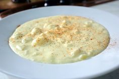 a white plate topped with food on top of a table