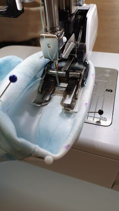 the sewing machine is being used to sew something on it's armrests