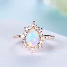 Opal ring, Opal engagement ring featuring a Pear cut Opal with moissanite halo, moissanite wedding band, anniversary ring in sterling silver / white gold plated/ rose gold plated / yellow gold plated / 10K/14K/18K solid gold available for you choose. Matching Band: https://www.etsy.com/listing/1030157128/moissanite-wedding-band Oval Black Quartz Rutilated Engagement Ring: https://www.etsy.com/listing/1024571706/oval-black-quartz-rutilated-engagement ❈Item detail❈ ✼Engagement ring: -Main stone: 8 Pear-shaped Halo Ring Gift, Teardrop Diamond Opal Ring For Anniversary, Pear-shaped Halo Ring For Promise, Teardrop Halo Diamond Ring For Wedding, Teardrop Halo Ring For Wedding, Teardrop Halo Diamond Ring For Anniversary, Halo Teardrop Diamond Ring For Anniversary, White Pear-shaped Halo Design Ring, White Pear-shaped Ring With Halo Design