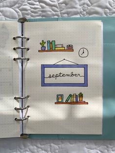 an open notebook with the words september written on it