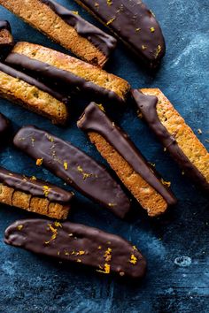 an assortment of cookies and pastries on a blue surface