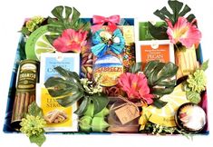 a gift box filled with lots of different types of food and flowers on top of each other