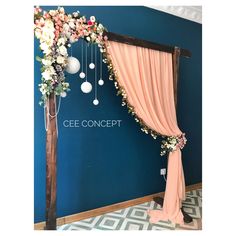 a wedding arch decorated with flowers and hanging balls for the ceremony stage at cee concept