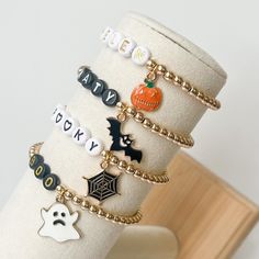 Some of my favorite bracelets ever! How cute are these adorable Halloween bracelets. Perfect for the fall and the months of October and September. I just love them! Choose your favorite or make it extra fun and get the entire stack. These bracelets are made with 4mm gold beads. They will not tarnish if they are properly cared for. Please keep away from any harsh chemicals and any soap. Please store in a cool, dry place.  Each bracelet is custom made for you with your choice of charm and bead col Halloween Gift Bracelets With Letter Beads, Personalized Halloween Beaded Bracelets, Novelty Beaded Bracelets For Halloween Gift, Customized Beaded Bracelets For Halloween Gift, Personalized Beaded Bracelets For Halloween, Halloween Novelty Bracelets Personalized, Novelty Personalized Halloween Bracelets, Spooky Halloween Bracelets For Gift, Spooky Halloween Gift Bracelets