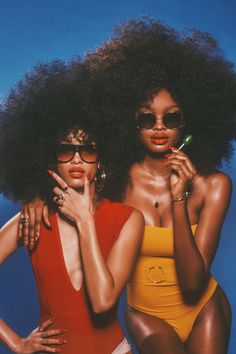 two women in swimsuits and sunglasses posing for an instagramtion photo together