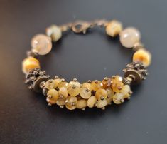 Handmade beaded cluster bracelet of natural faceted Gold Tiger's eye , genuine Rutilated quartz. Bronze accents.  Fits for 15.5-16.5cm wrist.  The bracelet comes in a gift box ready for gifting. You might also like earrings  https://www.etsy.com/uk/shop/LoveIuliia?ref=l2-about-shopname§ion_id=38529364 Not exactly what you are looking for? More of bracelets available here https://www.etsy.com/uk/shop/LoveIuliia?ref=l2-about-shopname§ion_id=38541683 Thank you so much for visiting my shop Iuliia xx Hand-strung Amber Bracelet Jewelry, Hand-strung Amber Bracelet, Artisan Bracelet With Faceted Beads, Yellow Faceted Beads Bracelet, Gold Bracelets With Faceted Beads, Artisan Faceted Bead Bracelet Jewelry, Elegant Handmade Amber Beaded Bracelets, Artisan Faceted Bead Bracelet, Brown Faceted Bead Bracelet