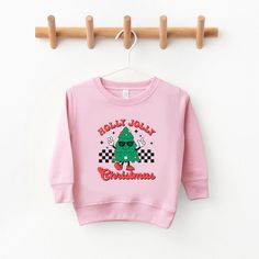 Looking for a cute sweatshirt for your kids? We have the perfect ultra-soft Holly Jolly Christmas Tree graphic sweatshirt addition to their closet! Also available in toddler sweatshirts. Holiday Cotton Sweatshirt With Graphic Print, Holiday Graphic Print Cotton Sweatshirt, Cute Christmas Sweatshirt With Letter Print, Cute Christmas Sweatshirt With Graphic Print, Cute Christmas Graphic Print Sweatshirt, Christmas Tree Hoodie, Toddler Christmas Tree, Christmas Tree Graphic, Cute Sweatshirts