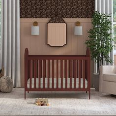 a baby's room with a crib, chair and mirror on the wall