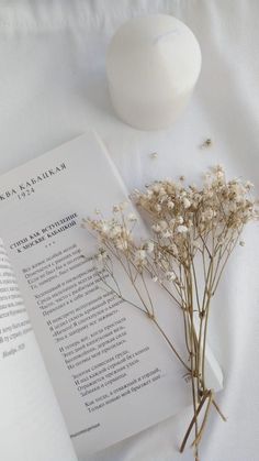 a book and some flowers on a table