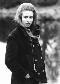 black and white photograph of a woman in coat