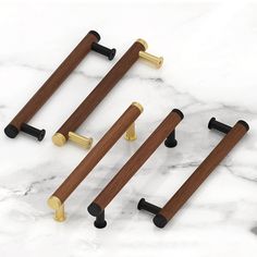 four wooden handles on marble counter top