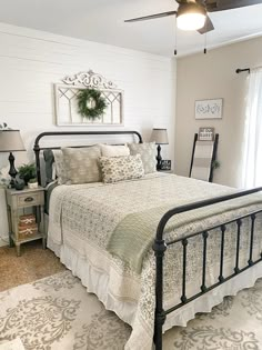 a bedroom with a bed, nightstands and ceiling fan in the middle of it