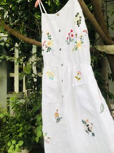 ❤ The white linen hand embroidered dress is very soft, skin friendly, breezy and comfortable. ❤ Item description: - A lovely dress with colourful embroidered wild flowers and bee motifs. You seem to be lost in a garden which full of fragrant flowers and strange grass. - Material: linen, coconut button, embroidery threads. - Environmentally friendly. - This dress is very useful, go with any outfit, that can be used to go to school, go out, go shopping. It is a perfect gift for yourself or your be Summer Linen Embroidered Dress For Garden Party, Summer Embroidered Linen Dress For Garden Party, Summer Floral Applique Embroidered Dress For Garden Party, Summer Garden Party Embroidered Linen Dress, Embroidered Flower Dress For Summer, White Linen Floral Print Dress, White Bohemian Embroidered Linen Dress, White Linen Dress With Floral Print, White Summer Cottagecore Dress