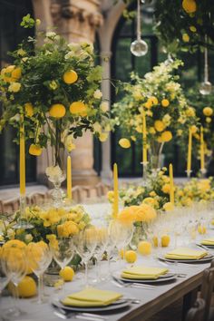 a long table is set with yellow flowers and candles for a formal dinner or party