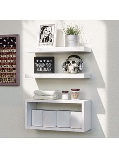 two white shelves with pictures and other items on them, one has a skull in the middle