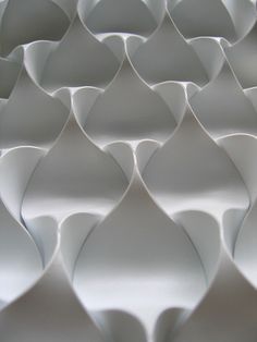 an abstract pattern made up of white paper